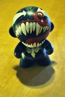 a toy with venom painted on it is on a table