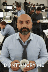 a man with a beard is holding a cup of coffee and says " dont angry me " on the bottom
