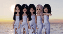 a group of dolls are standing next to each other on the beach