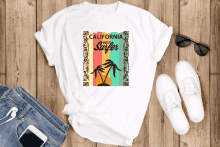 a california best surfer t-shirt is laying on a wooden table