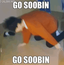 a person is laying on their stomach on the floor with the words `` go soobin '' written on it .