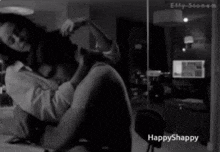 a black and white photo of a woman hugging a man with the words happyshappy on the bottom