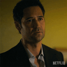 a close up of a man 's face with a netflix logo on the bottom