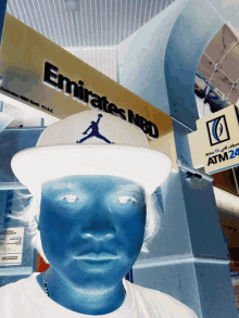 a man stands in front of a emirates nbd sign