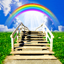 a staircase leading to a rainbow in the sky