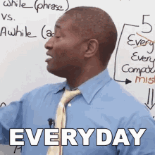 a man in a blue shirt and tie stands in front of a white board with the word everyday on it