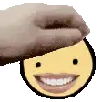 a hand is putting a smiley face on top of a smiley face .