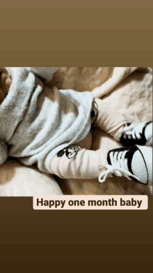 a baby is laying on a bed with the words happy one month baby below it