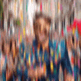 a blurry picture of a man in a blue shirt surrounded by confetti