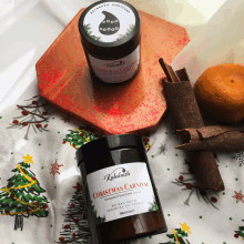 a bottle of kalabash christmas carnival sits on a christmas table cloth