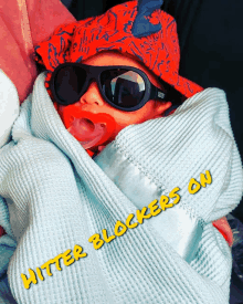 a baby wearing sunglasses and a pacifier with the words hitter blockers on