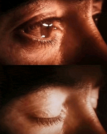 a close up of a person 's eye with a dark background