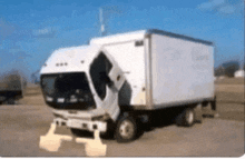 a white truck is parked in a dirt lot with its door open