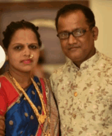 a man and a woman pose for a picture with the woman wearing a nose ring