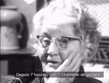 a black and white photo of a woman with glasses and the caption depuis 7 heures non charrette de gaillard