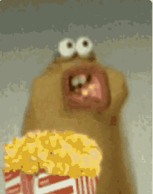 a cartoon character holding a bucket of popcorn