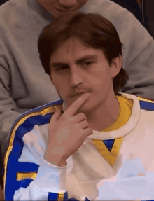 a man wearing a blue and yellow jersey with the letter e on it
