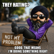 a man in a turban sits in a chair with a sign that says not my problem