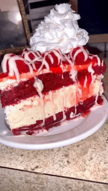 a red velvet cheesecake with whipped cream on top