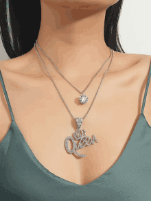 a woman wearing a necklace with a pendant that says mr. queen