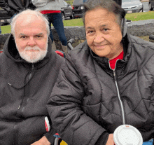 a man and a woman are posing for a picture and the man has a beard