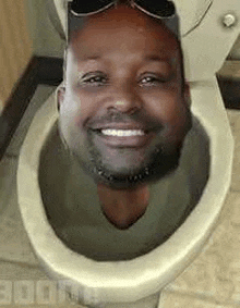 a man is sitting in a toilet with his head sticking out of it and smiling .