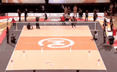 a volleyball court with the letter m on the floor