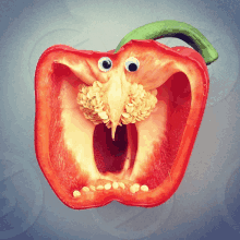 a red pepper with googly eyes and a bird face