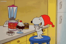 snoopy is sitting on a stool in a kitchen eating ice cream