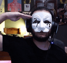 a man wearing headphones and a mask with the number 7 on his face