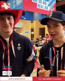 two boys wearing cowboy hats are standing next to each other in front of a sign that says olympic channel