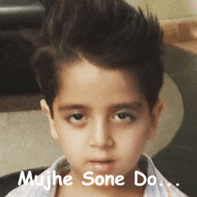 a young boy with a mohawk looks at the camera with the words mujhe sone do written below him