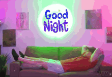 a man laying on a couch under a sign that says " good night "