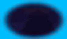 a blurred image of a purple circle on a blue background .