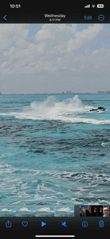 a phone screen shows a jet ski in the ocean on wednesday at 10:51 pm