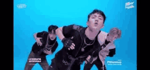 a group of men are dancing on a blue background .