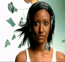 a woman wearing headphones looks at the camera