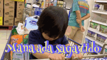 a child is pushing a shopping cart with the words mana ada saga tido on the bottom