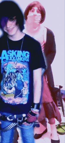 a person wearing a black shirt that says asking alexandria