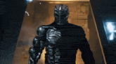 a man in a skeleton costume is standing in a doorway