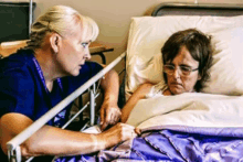 a nurse talks to an older woman in a hospital bed