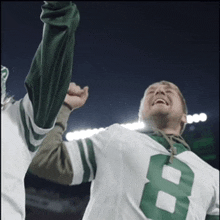 a man in a green and white jersey with the number 8