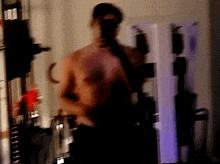 a blurry picture of a shirtless man taking a selfie