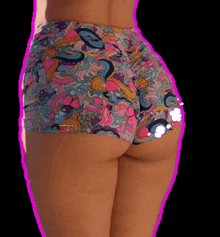 a woman is wearing a pair of shorts with a colorful pattern on them