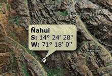 an aerial view of a mountain range with a speech bubble showing the coordinates of the location .