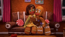 a gingerbread man and a woman are sitting on a couch in a gingerbread house