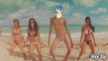 a group of women in bikinis are dancing on the beach with a man without a shirt .