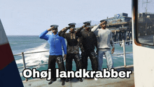 a group of men salute in front of the ocean with the words ohoj landkrabber below them