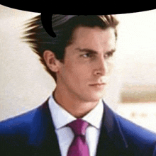 a man in a suit and tie with a speech bubble behind him .