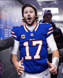 a man wearing a blue bills jersey with the number 17 on it